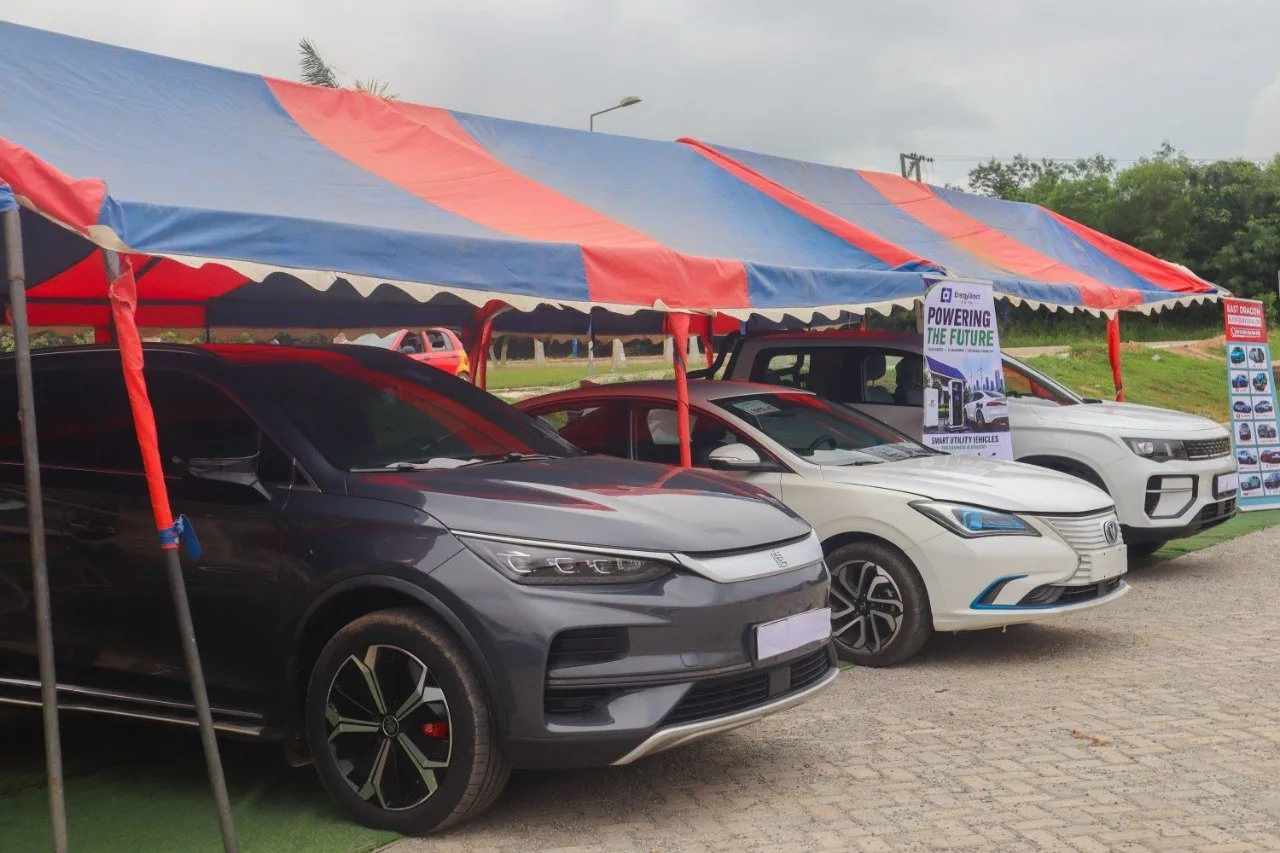 A row of electric cars under the exhibition tents