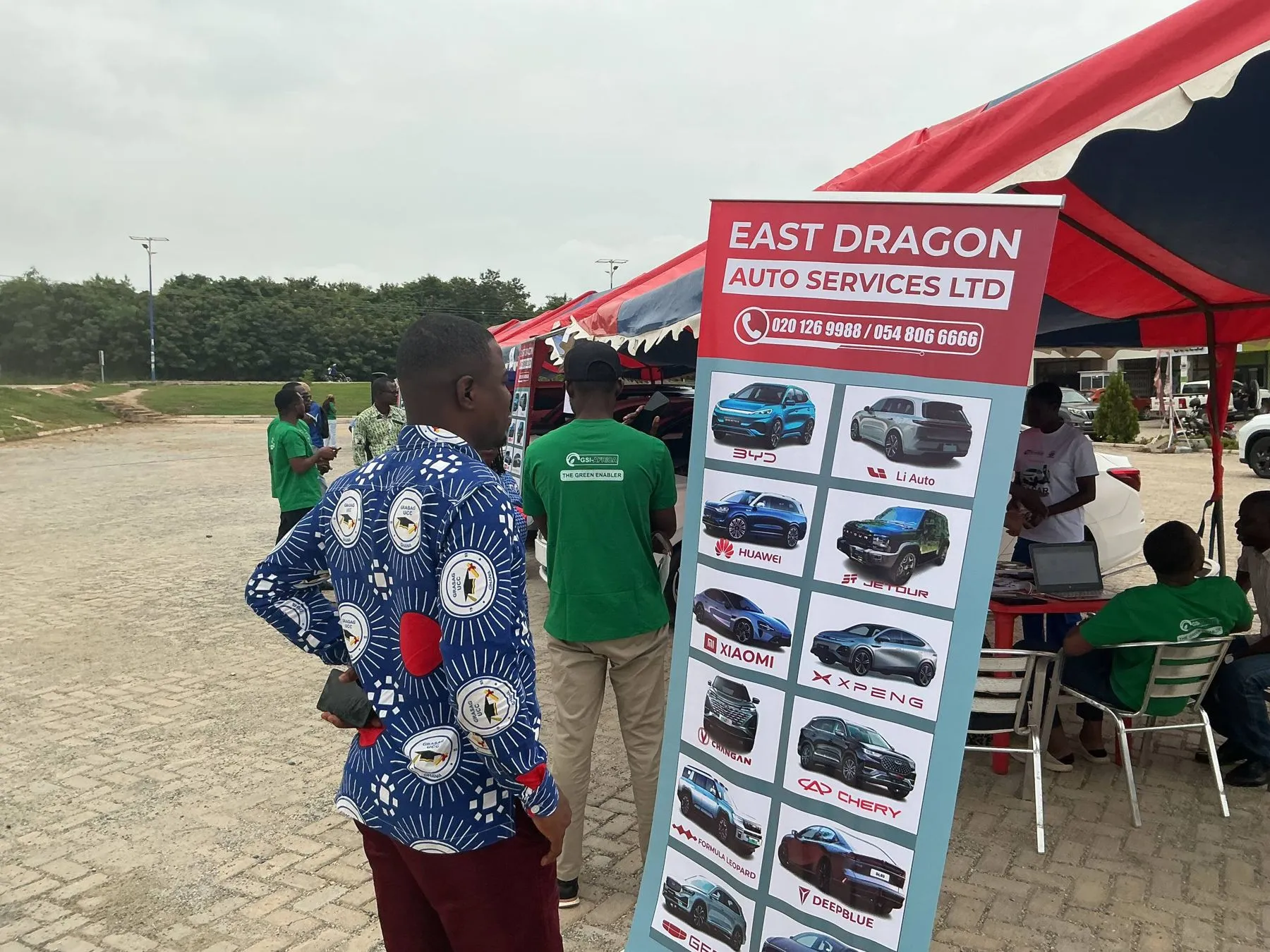 The East Dragon Auto Services stand with vehicle posters
