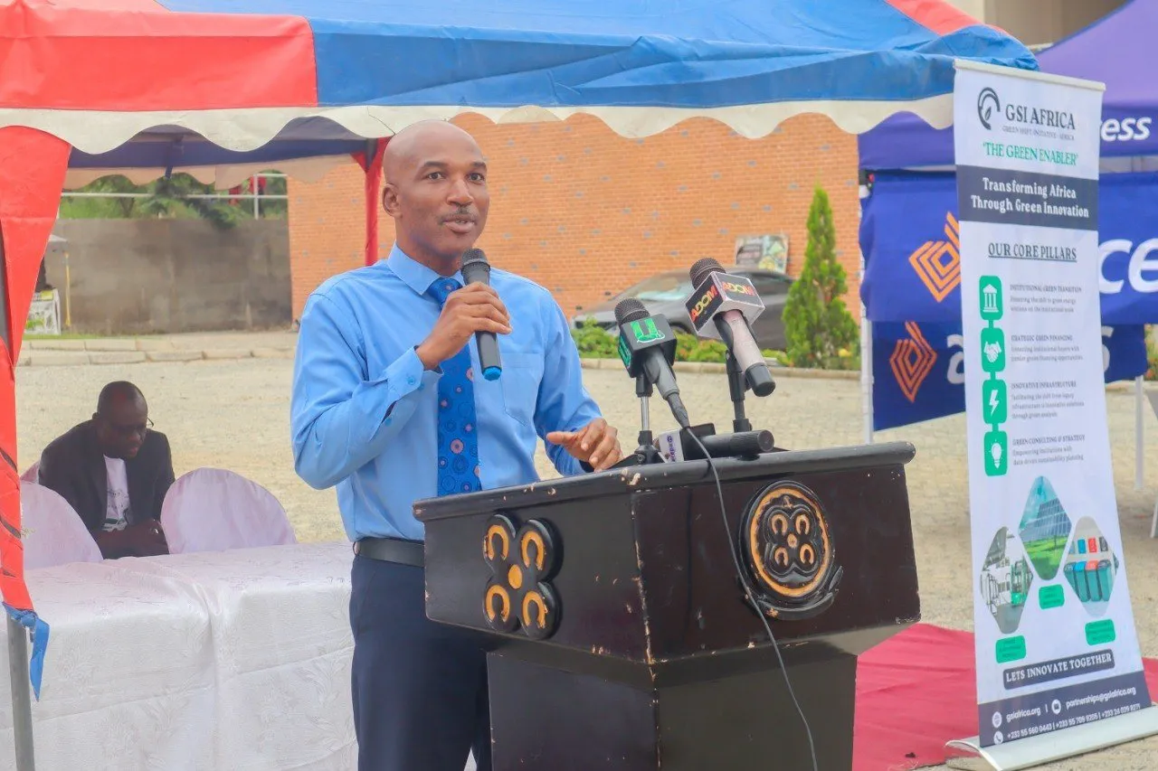 A speaker at the podium opening the exhibition, beside a GSI Africa banner