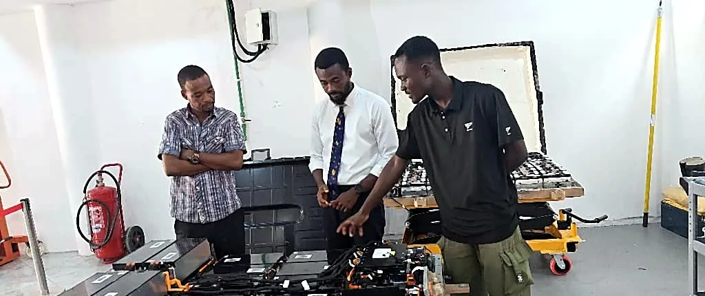 GSI team members inspecting electric vehicle battery packs in a workshop