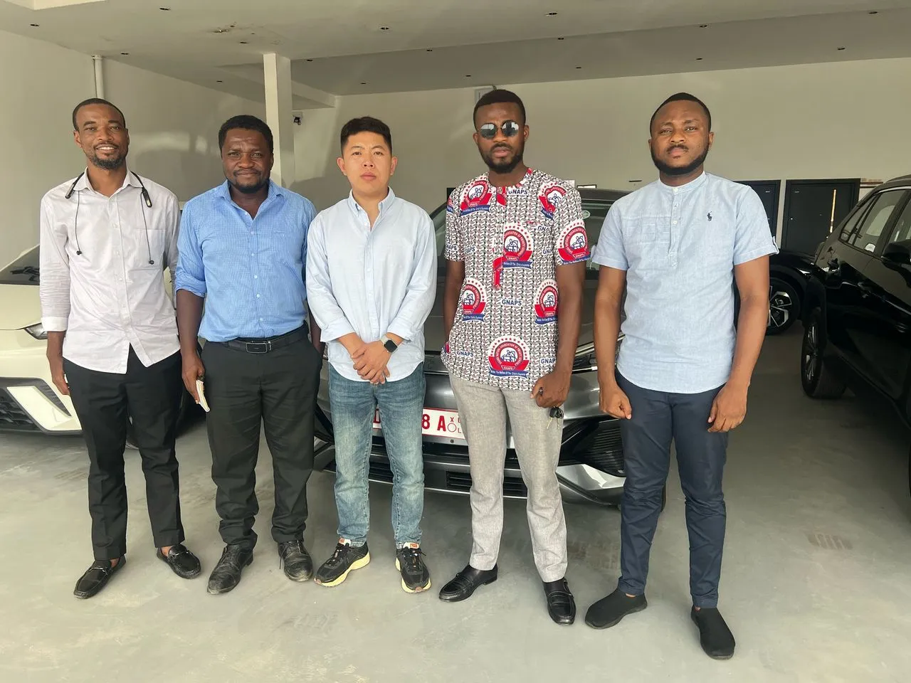 The GSI team with a supplier in a vehicle showroom